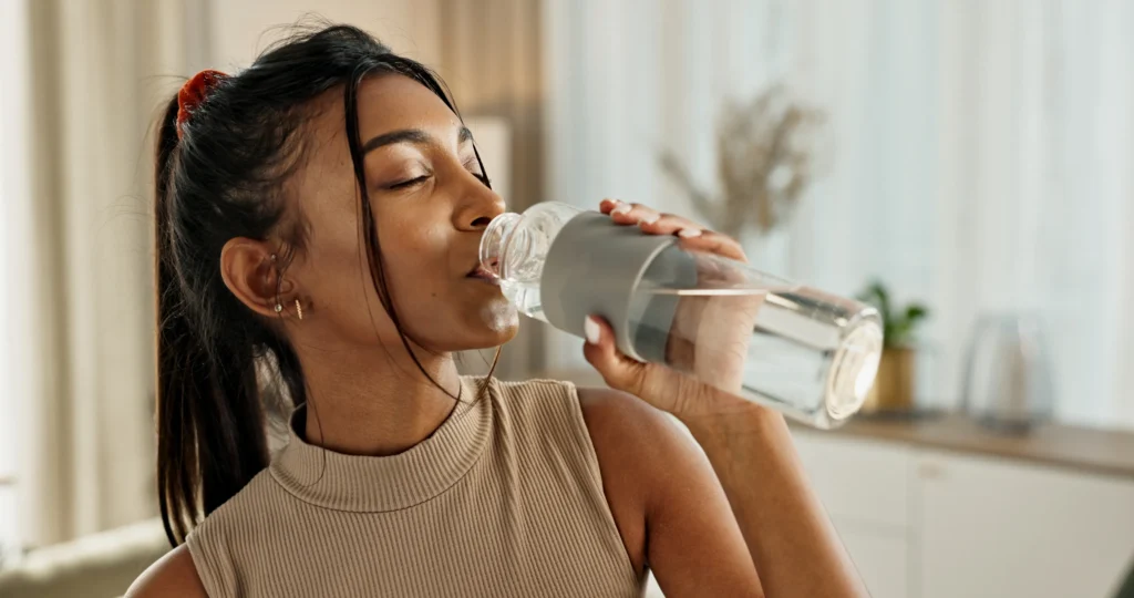 A young women drinking water.