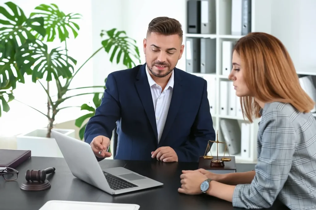 A person with a lawyer interacting with a laptop.