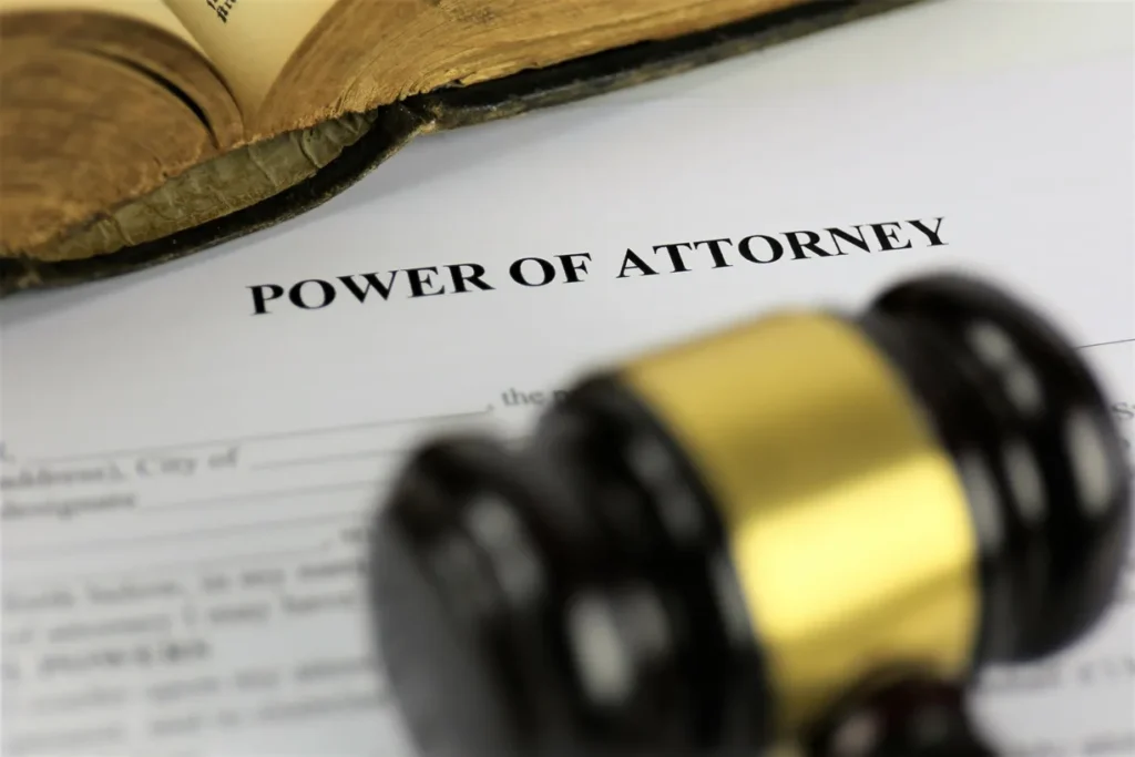 A power of attorney document and a gavel on a table.